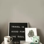 Sign saying "travel is good for the soul"