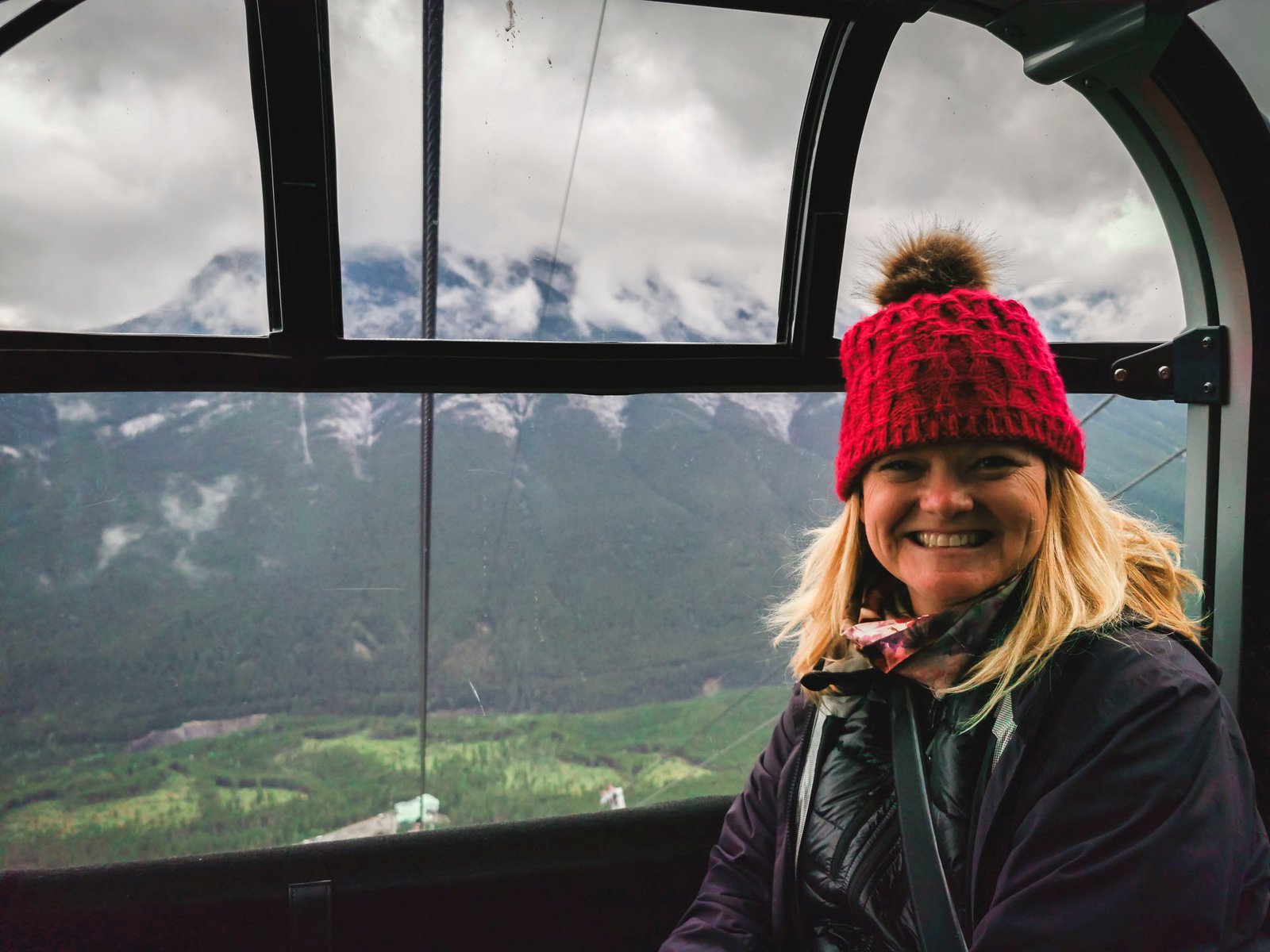 Deb from The Planet D on the Jasper SkyTram on Whistlers Mountain with a stunning panoramic view of the Rocky Mountains in the background