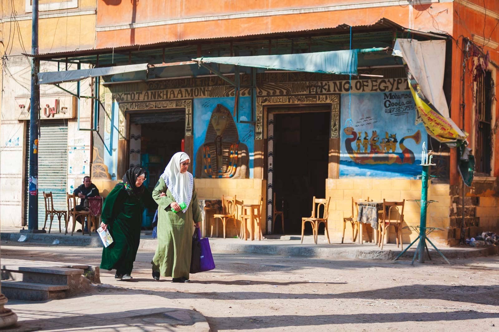 A bustling street in Cairo with pedestrians, showing daily life and contrasting with outdated news reports.