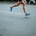 Runner's legs with blue and pink sneakers