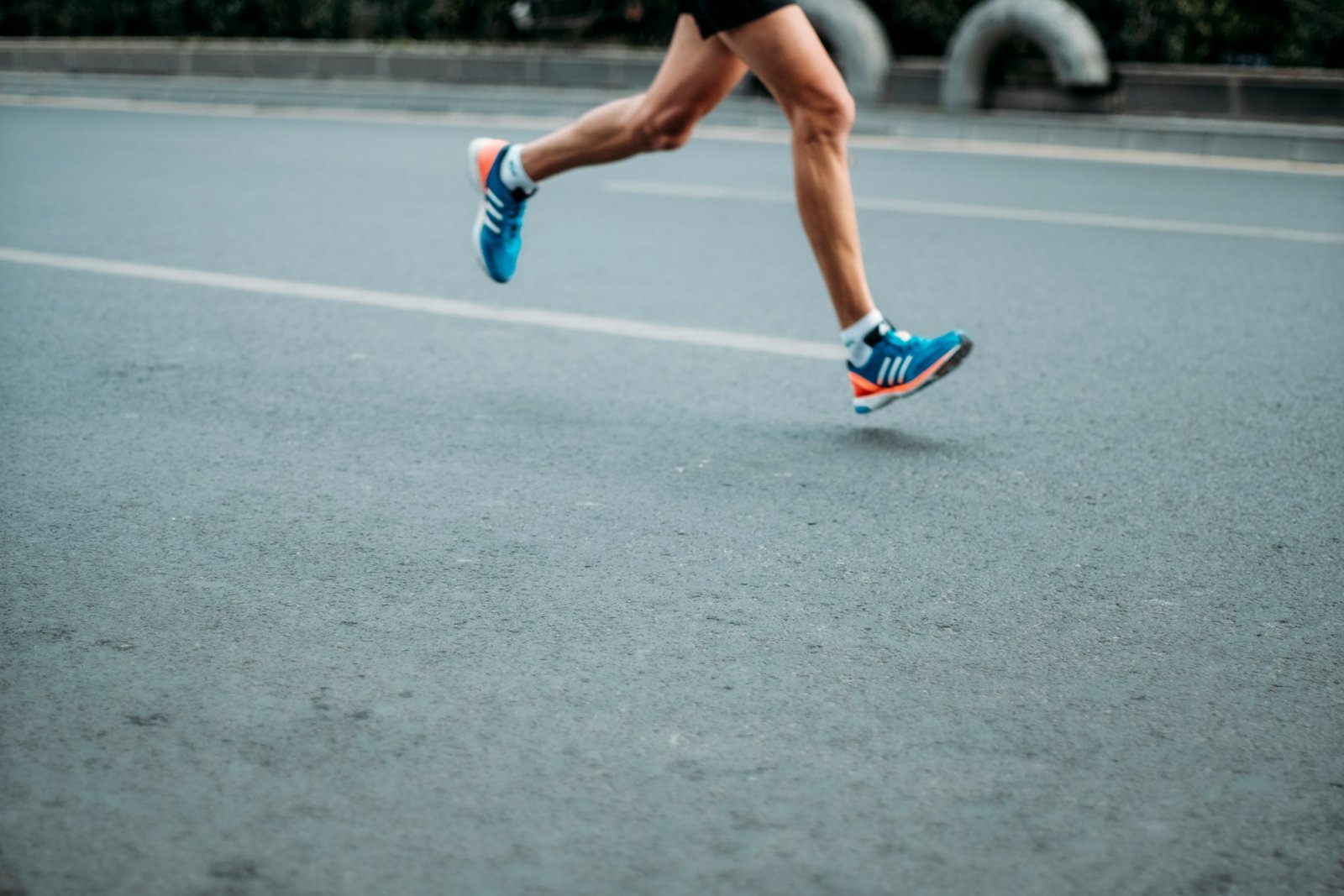 Runner's legs with blue and pink sneakers